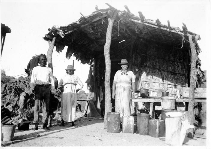 A group of people under a shelter. 
